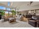 Open-concept living room with large windows, vaulted ceilings, and seamless flow into the kitchen at 4839 Bandera Pl, Parker, CO 80134