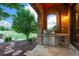 Outdoor kitchen with stone archway and complete with a stainless steel grill and beverage cooler at 4839 Bandera Pl, Parker, CO 80134