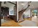Staircase with carpeted steps and ornate wrought iron railing open to office and living spaces at 4839 Bandera Pl, Parker, CO 80134