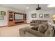 Home theater with a large screen, custom shelving, and comfortable seating at 4839 Bandera Pl, Parker, CO 80134