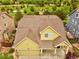 Aerial view of a charming home with a well-maintained lawn and easy access to nearby playground and green spaces at 11649 E 111Th Ave, Commerce City, CO 80640