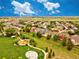 A beautiful neighborhood with a playground and green space features charming homes under a vast blue sky with fluffy clouds at 11649 E 111Th Ave, Commerce City, CO 80640