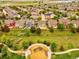A scenic aerial shot of a neighborhood with a playground and lush green spaces and colorful homes at 11649 E 111Th Ave, Commerce City, CO 80640