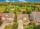 Aerial view of a well-maintained neighborhood with mature trees and green spaces at 11649 E 111Th Ave, Commerce City, CO 80640