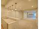This basement has a bar with granite countertops and pendant lighting, as well as carpeted floors at 11649 E 111Th Ave, Commerce City, CO 80640