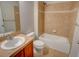 Cozy bathroom featuring tiled walls, a soaking tub, and a vanity with sink at 11649 E 111Th Ave, Commerce City, CO 80640