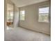 Spacious bedroom with natural light from two windows and an open view of the adjoining bathroom at 11649 E 111Th Ave, Commerce City, CO 80640