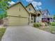 Charming home with a covered front porch and attached two-car garage at 11649 E 111Th Ave, Commerce City, CO 80640