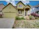Charming home with a covered front porch and attached two-car garage at 11649 E 111Th Ave, Commerce City, CO 80640
