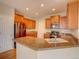 Spacious kitchen featuring a granite island with sink, stainless steel appliances, and ample cabinet space at 11649 E 111Th Ave, Commerce City, CO 80640