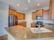 Bright kitchen featuring granite countertops, ample cabinet space, and stainless steel appliances at 11649 E 111Th Ave, Commerce City, CO 80640