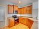 Well-lit kitchen showcasing wood cabinets, granite countertops, and stainless steel appliances at 11649 E 111Th Ave, Commerce City, CO 80640