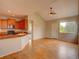 Open-concept living space with hardwood floors, a modern ceiling fan, and a bright, airy atmosphere at 11649 E 111Th Ave, Commerce City, CO 80640