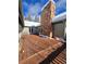 Back deck showcasing an impressive stone chimney with snow-covered trees in the background at 2218 Witter Gulch Rd, Evergreen, CO 80439