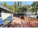 Back deck with furniture, grill, and backyard access perfect for outdoor enjoyment and entertaining at 2218 Witter Gulch Rd, Evergreen, CO 80439