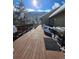 Expansive wooden back deck with an outdoor grill and a snow-covered mountain backdrop at 2218 Witter Gulch Rd, Evergreen, CO 80439