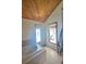 Bathroom with soaking tub, wood ceiling, and windows offering natural light and winter views at 2218 Witter Gulch Rd, Evergreen, CO 80439