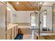 Bright bathroom features a soaking tub, a separate glass enclosed shower and blond wood vanity at 2218 Witter Gulch Rd, Evergreen, CO 80439