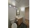 Bathroom featuring a toilet, vanity, decorative mirror and track lighting at 2218 Witter Gulch Rd, Evergreen, CO 80439