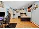 Bedroom with wood flooring, light blue walls, Colorado flag, desk with black gaming chair, and closet at 2218 Witter Gulch Rd, Evergreen, CO 80439