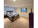 Bedroom with carpeted floors, blue accent wall and window at 2218 Witter Gulch Rd, Evergreen, CO 80439