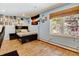 Bedroom with wood flooring, light blue walls, Colorado flag, and window overlooking backyard at 2218 Witter Gulch Rd, Evergreen, CO 80439