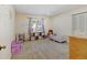 Bedroom with carpet, a window with backyard views, and a variety of stuffed animals at 2218 Witter Gulch Rd, Evergreen, CO 80439