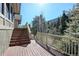 Exterior view of the stairs leading up to the deck, showcasing the surrounding trees and mountain at 2218 Witter Gulch Rd, Evergreen, CO 80439