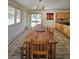 Rustic dining area featuring a wooden table, tile floors, and windows for natural light, perfect for gatherings at 2218 Witter Gulch Rd, Evergreen, CO 80439