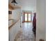 Inviting entryway with tile flooring leading to the wooden double doors with winter views at 2218 Witter Gulch Rd, Evergreen, CO 80439