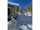 Exterior view of home surrounded by snow and pine trees at 2218 Witter Gulch Rd, Evergreen, CO 80439