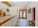 Hallway with tile floors, wood accents, leading to an outdoor patio through glass doors at 2218 Witter Gulch Rd, Evergreen, CO 80439