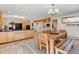 Open kitchen with stone tile flooring, light wood cabinetry, and a dining table with wood bench seating at 2218 Witter Gulch Rd, Evergreen, CO 80439