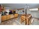 Open layout combining a rustic wood table, light wood cabinets, and tile flooring for a cozy space at 2218 Witter Gulch Rd, Evergreen, CO 80439