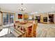 Eat-in kitchen featuring wooden table, custom cabinetry, black appliances, and sliding glass doors to the outdoor deck at 2218 Witter Gulch Rd, Evergreen, CO 80439