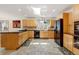 Spacious kitchen with custom cabinets, black appliances, tile flooring, and a large window with scenic views at 2218 Witter Gulch Rd, Evergreen, CO 80439