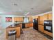 Bright kitchen showcasing light wood cabinets, black appliances and a skylight, creating a modern space at 2218 Witter Gulch Rd, Evergreen, CO 80439