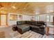 Spacious living room with wood ceilings, and kitchenette and leather sofa at 2218 Witter Gulch Rd, Evergreen, CO 80439