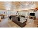 Spacious living room with wooden ceiling, leather couch, pool table and several windows at 2218 Witter Gulch Rd, Evergreen, CO 80439