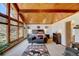 Bright main bedroom featuring vaulted ceiling, exposed wood beams, neutral carpet and a comfortable seating area at 2218 Witter Gulch Rd, Evergreen, CO 80439