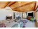 Spacious main bedroom showcases vaulted ceiling, a door to the outside and views of surrounding landscape at 2218 Witter Gulch Rd, Evergreen, CO 80439