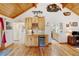 Built-in wet bar area with mini fridge and wood cabinetry in open concept living area at 2218 Witter Gulch Rd, Evergreen, CO 80439