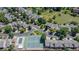 Aerial view shows community amenities including a pool, tennis courts, green spaces, pond, and well-maintained homes at 12668 W 1St Pl # 81, Denver, CO 80228