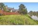 A grassy backyard with fence and water at 12668 W 1St Pl # 81, Denver, CO 80228