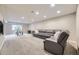 Spacious basement with a large sectional sofa, carpet flooring, and recessed lighting at 12668 W 1St Pl # 81, Denver, CO 80228