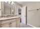 Well-lit bathroom with a granite countertop vanity, tiled backsplash, and neutral paint at 12668 W 1St Pl # 81, Denver, CO 80228
