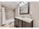 Bathroom featuring granite countertop vanity, neutral tiling, and a shower-tub combo at 12668 W 1St Pl # 81, Denver, CO 80228
