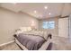 Cozy bedroom with carpet flooring, neutral paint, and a large window allowing natural light at 12668 W 1St Pl # 81, Denver, CO 80228