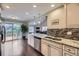 Charming kitchen featuring granite countertops, stainless appliances, and access to the outdoor deck at 12668 W 1St Pl # 81, Denver, CO 80228