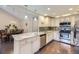 Bright kitchen featuring granite counters, white cabinets, stainless steel appliances, and dark wood flooring at 12668 W 1St Pl # 81, Denver, CO 80228
